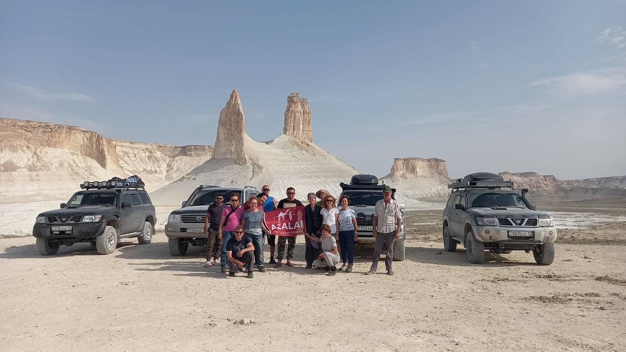Our guests and team standing in front of jeeps and Bozzhira